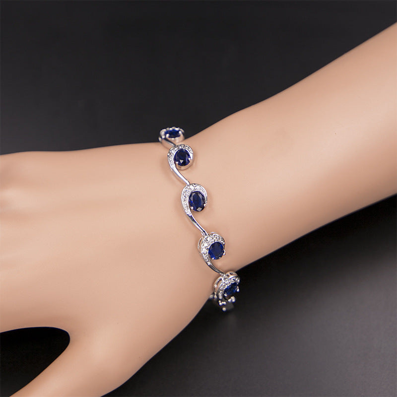 Elegant sapphire cubic zirconia swirl bracelet