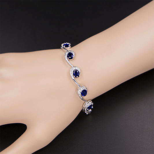Elegant sapphire cubic zirconia swirl bracelet